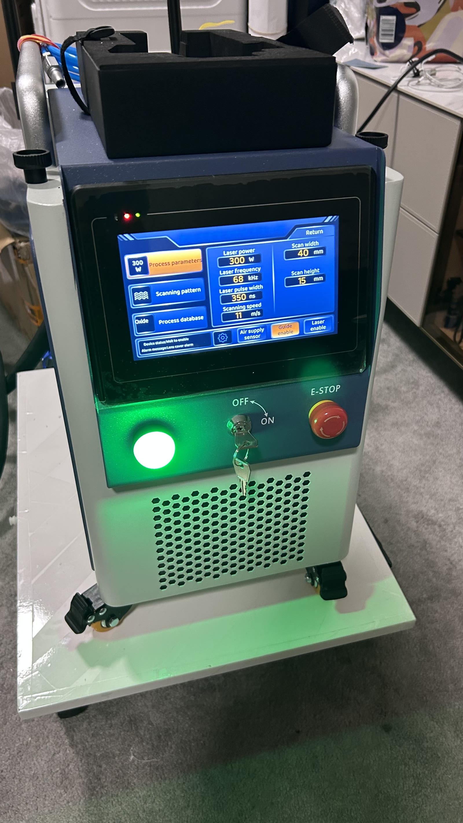 META MPW300 portable pulsed laser cleaner — actual machine, touchscreen showing live operating parameters: 300W power, 68 kHz frequency, 350 ns pulse width
